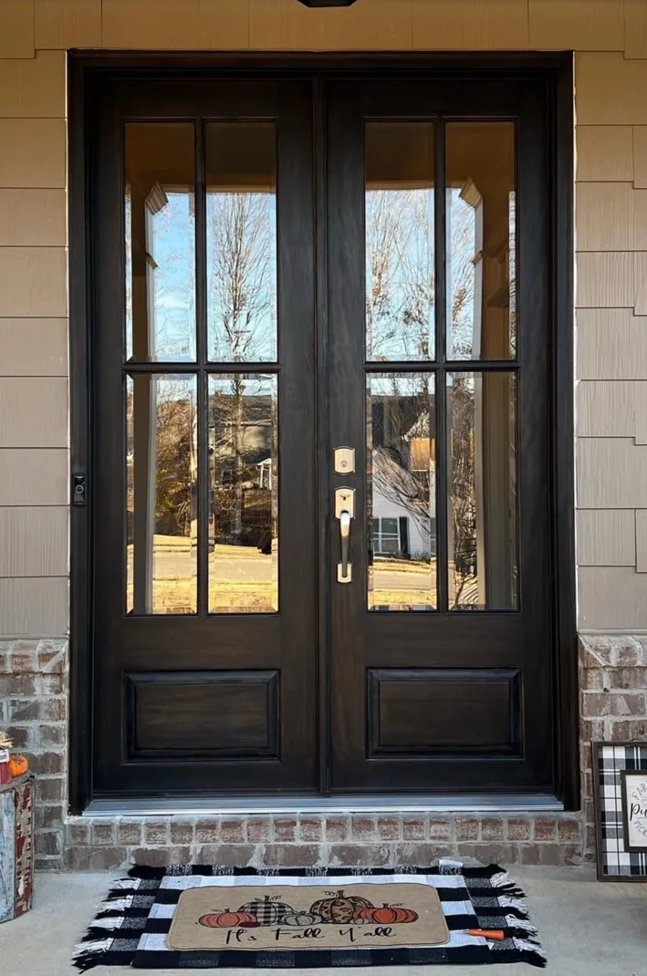 Dark stained double entry doors with divided glass panes