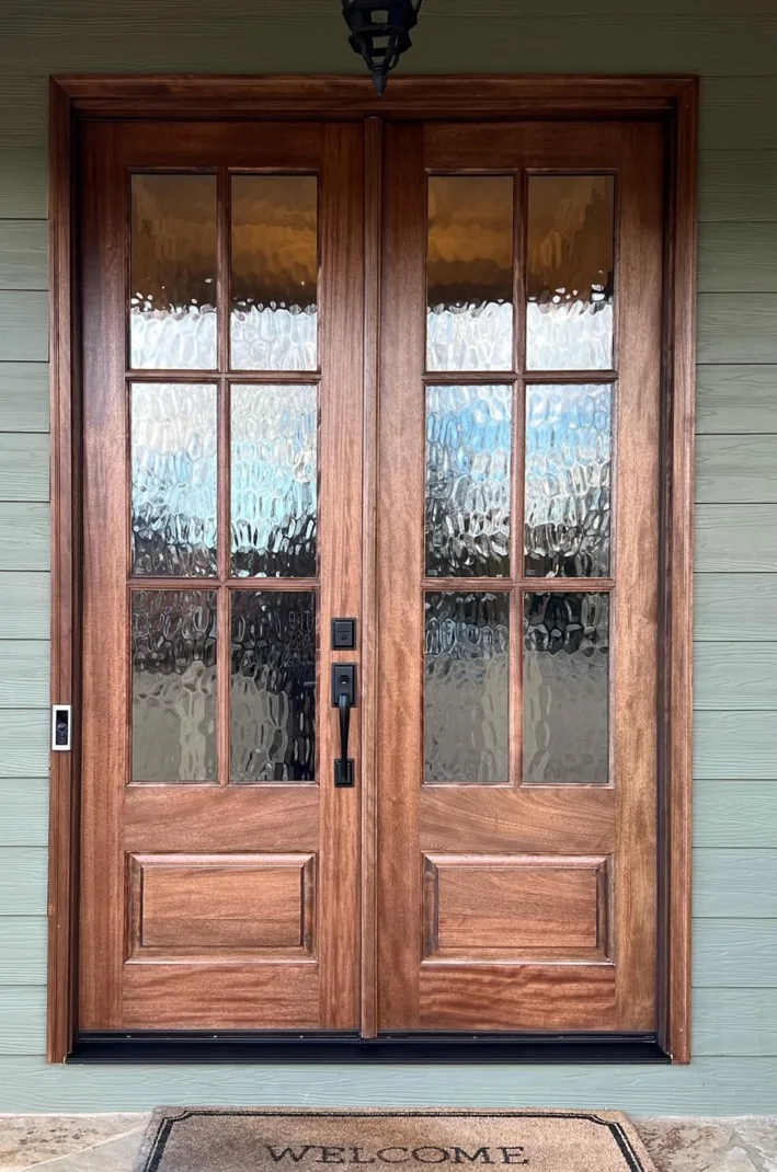 Mahogany-tone double entry doors with textured glass