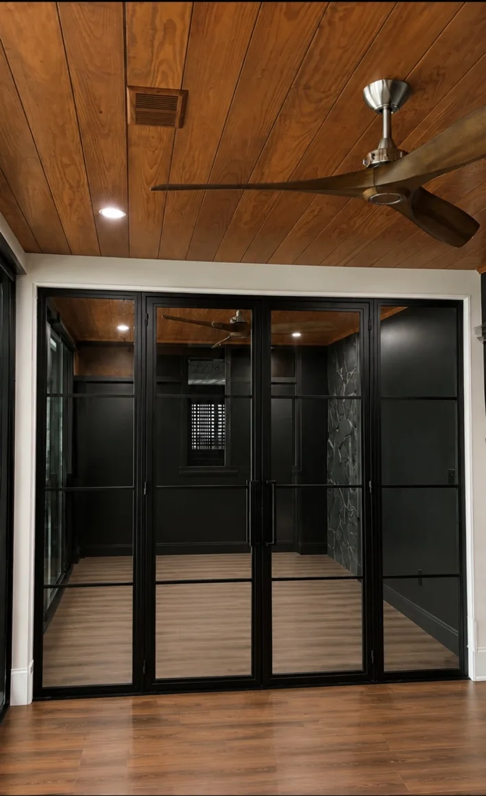 Black framed glass door system showcasing precision glass and frame work