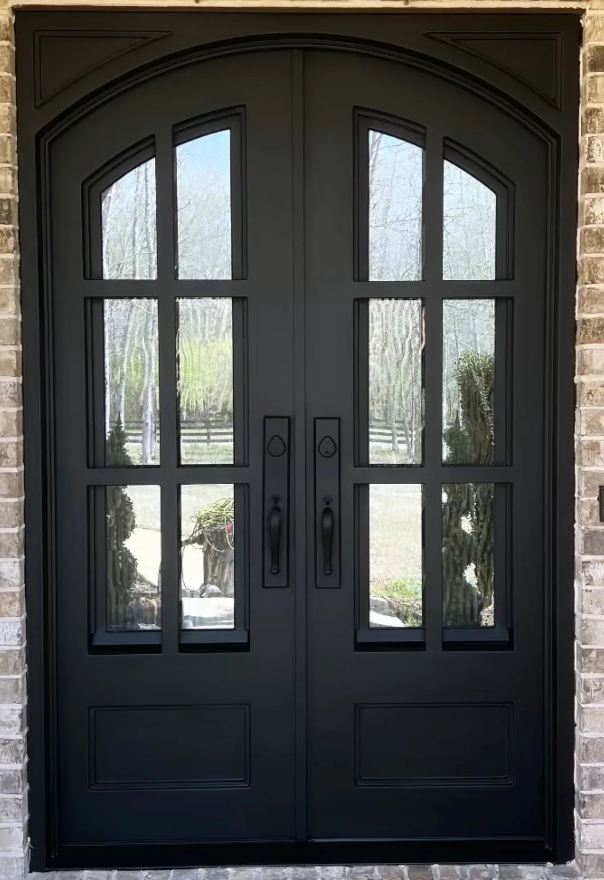 Black double entry doors after refinishing with a smooth restored finish