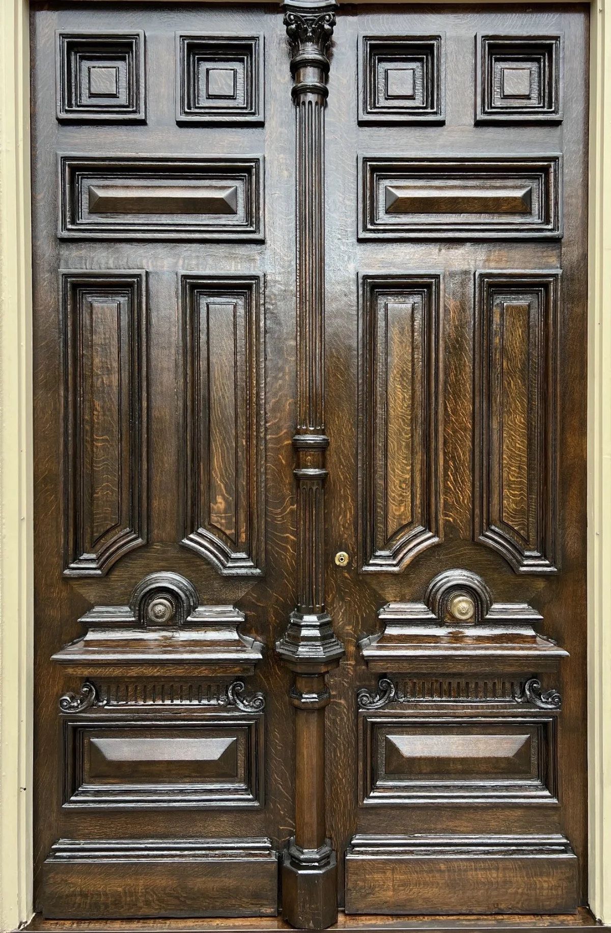 Ornate carved wood double doors after refinishing