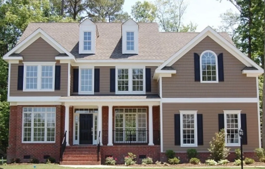 Two-story home with white replacement windows